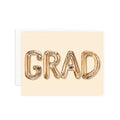 Graduation card with 'GRAD' in metallic letters on a beige background