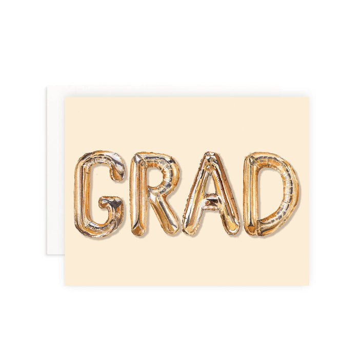 Graduation card with 'GRAD' in metallic letters on a beige background