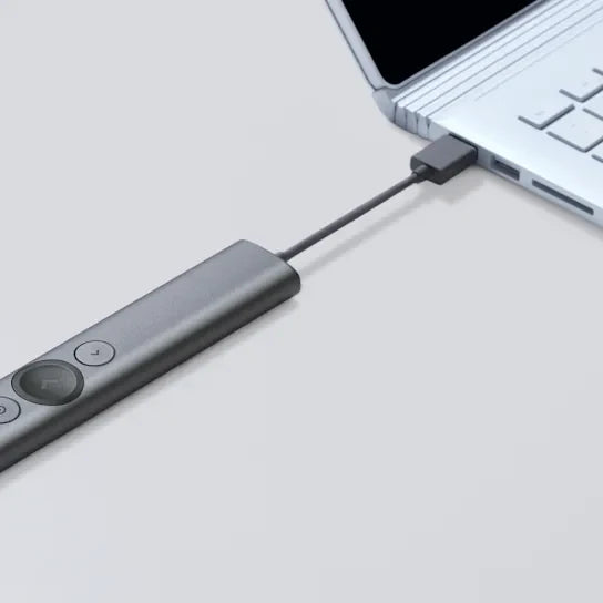 USB-C adapter connected to a laptop on a light gray background