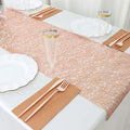 Elegant table setting with pink runner, plates, and utensils.