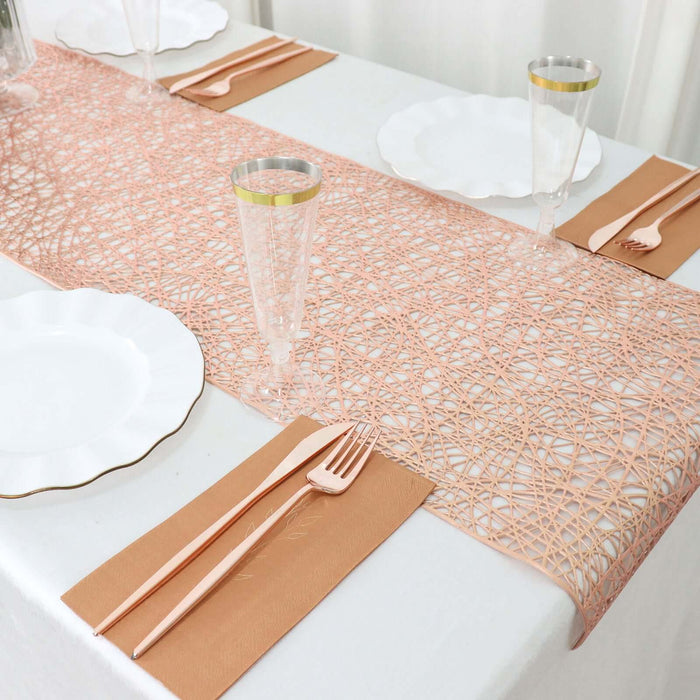 Elegant table setting with pink runner, plates, and utensils.