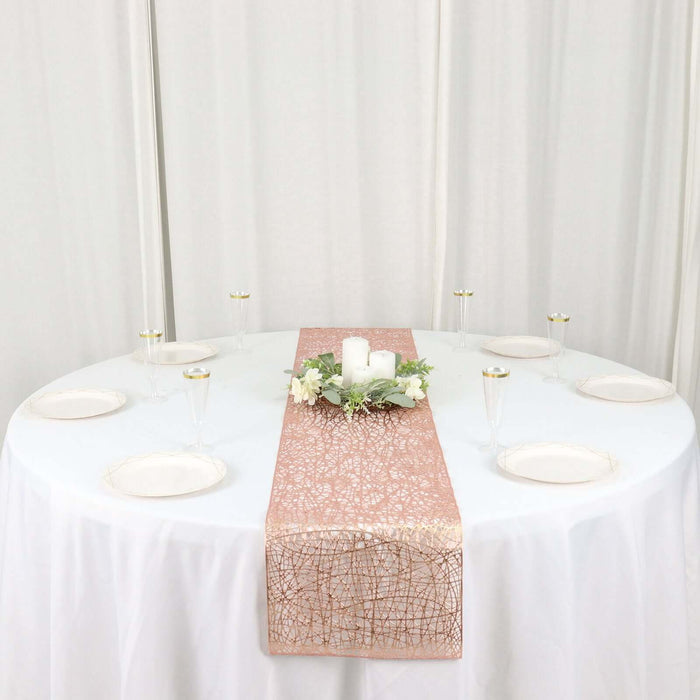 Elegant rose gold table runner on a round table set for a celebration.