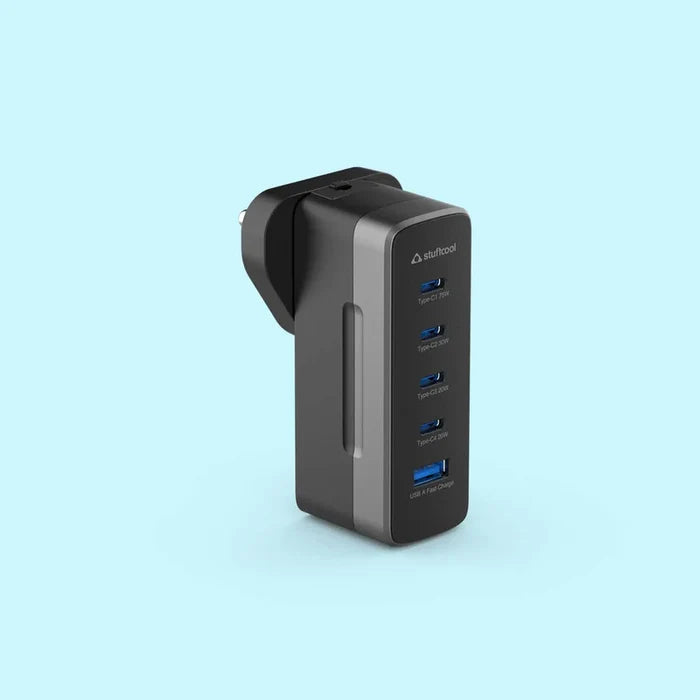 A black and dark gray 4-port USB-C charger by daFuCooz, shown from a three-quarter angle on a light blue background.