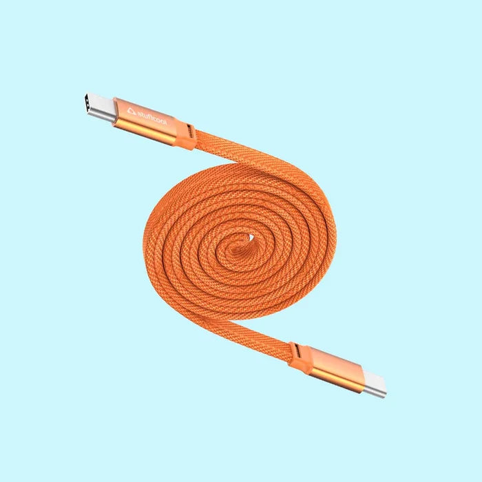 An orange braided USB-C to Lightning cable coiled in a spiral, featuring metallic gold-toned connector housings on a light blue background.